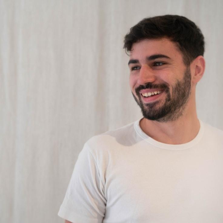 Kaveri Mehta, Lead Design Curator at MeadowPaperLane, reviewing corporate floral arrangements